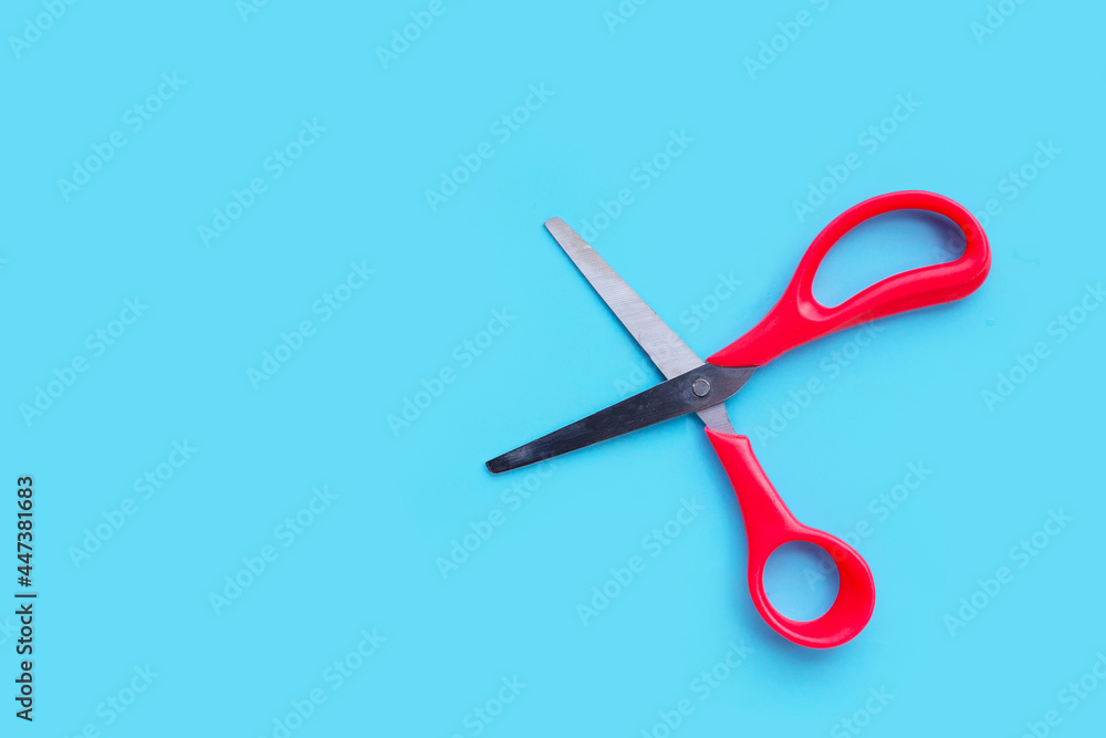 Scissors on blue background. Top view Scissors on blue background. Top view