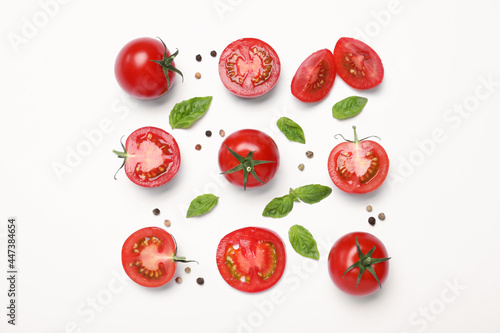 Fresh basil leaves and tomatoes on white background, flat lay