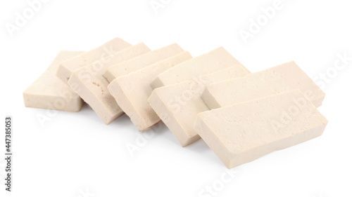 Slices of delicious raw tofu on white background