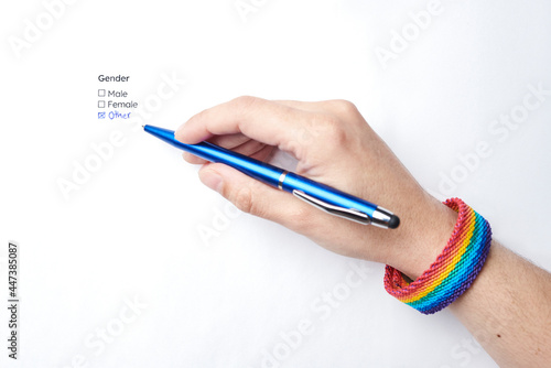 Hand writing and marking the handwritten option other in a form, with a rainbow