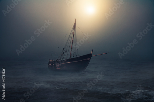 Sailboat in the sea floats in the moonlight, thick fog descended on the water after the storm. Fantasy landscape.