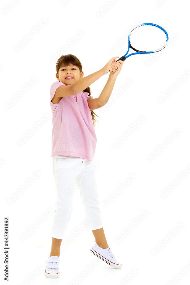 A little girl holds a tennis racket in her hands. Game, sports concept. A little girl holds a tennis racket in her hands. Game, sports concept.