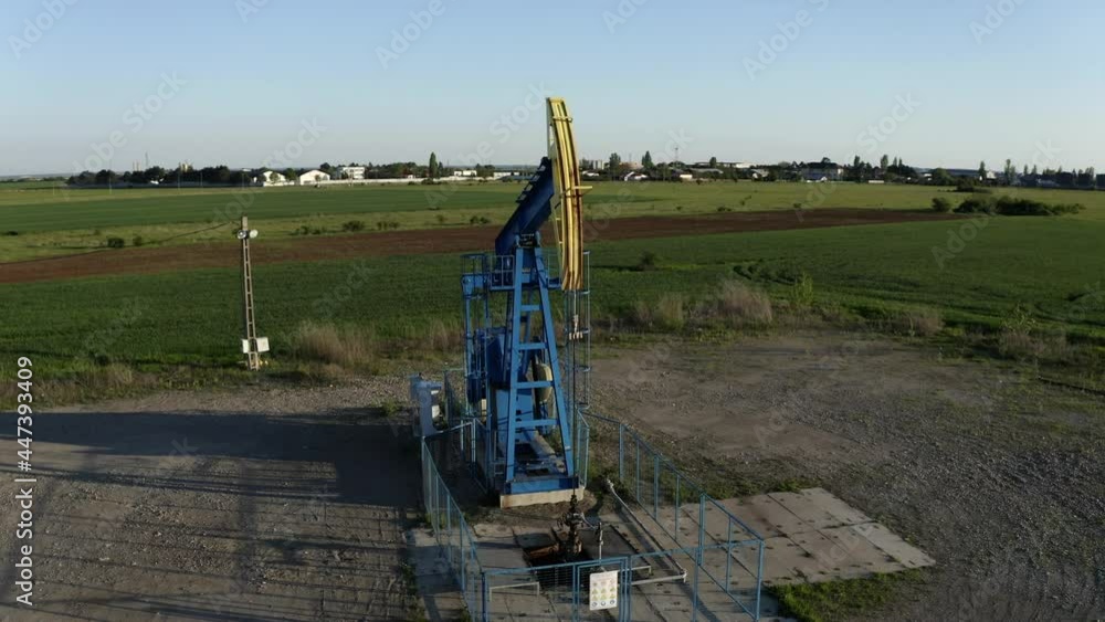 Aerial left to right pan around oil pumpjack, Ploiesti, Romania. Parallax effect Aerial left to right pan around oil pumpjack, Ploiesti, Romania. Parallax effect