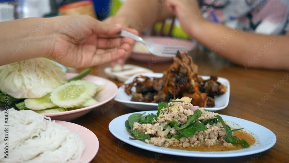 Friends eating food together, close up food on table Friends eating food together, close up food on table