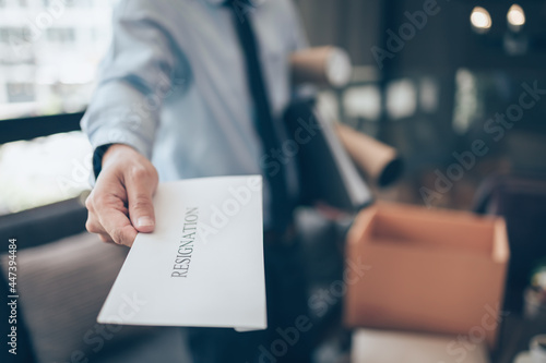 Businessman sending and showing resignation letter to employer boss. Quiting a job, businessman fired or leave a job concpet.