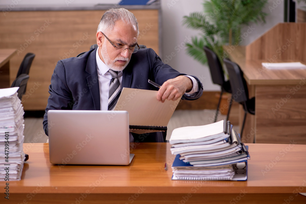 Old male employee and too much work in the office Old male employee and too much work in the office