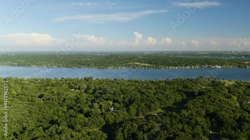 Aerial Sliding Shot Along Big Blue Lake, Reveals Suburban Homes and Golf Course. Lake Geneva, Wisconsin photo