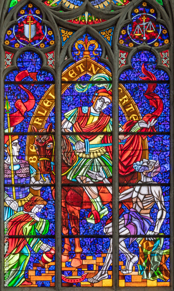 VIENNA, AUSTIRA - JUNI 24, 2021: The  St. Martin on the modern stained glass in the Votivkirche church from 20. cent.