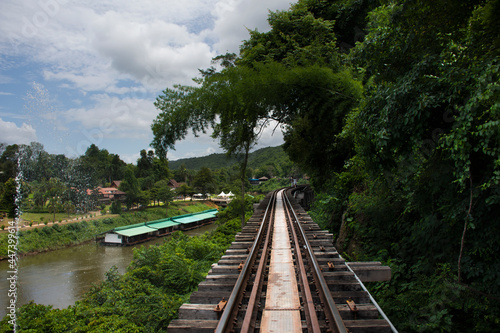 Train railway track between hellfire pass mountain and Si Sawat or Khwae Kwai river with forest jungle wildness in Sai Yok National Park for travel visit at Tham krasae cave in Kanchanaburi, Thailand