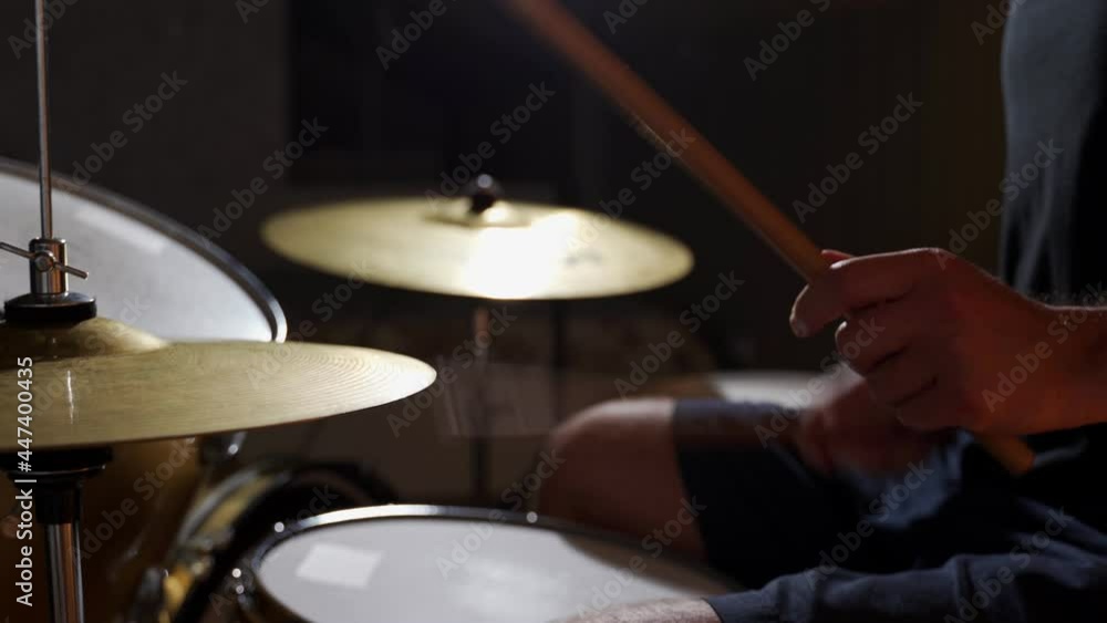 Close-up drummer rehearsing on drums before rock concert. Close-up drummer rehearsing on drums before rock concert.