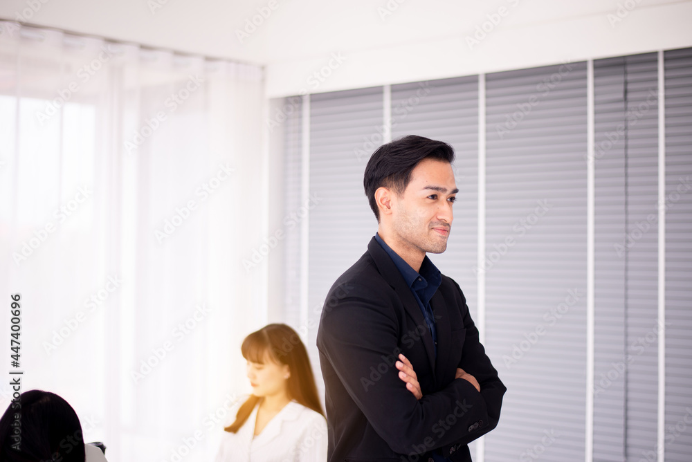 Business asian man smiling face and looking to people at office Business asian man smiling face and looking to people at office
