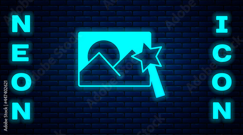 Glowing neon Photo retouching icon isolated on brick wall background. Photographer, photography, retouch icon. Vector