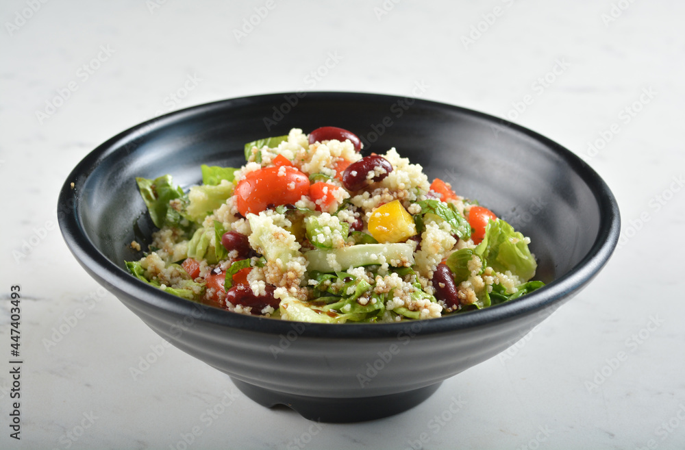 couscous healthy grain salad bowl with corn, bean, carrot and salad dressing sauce in white marble healthy poke bowl menu couscous healthy grain salad bowl with corn, bean, carrot and salad dressing sauce in white marble healthy poke bowl menu