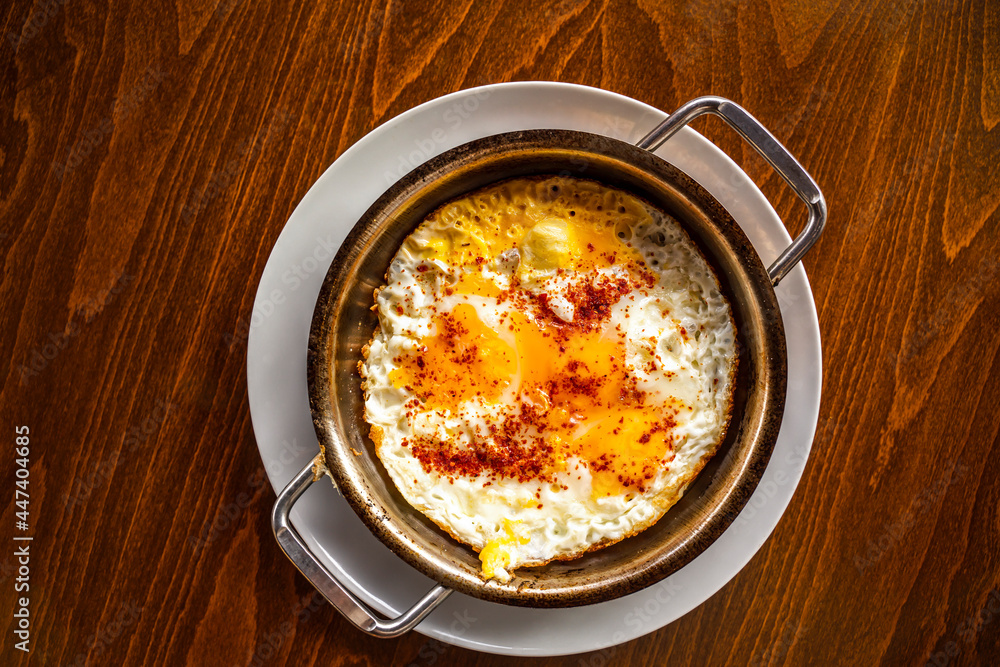 Delicious fried eggs on wooden background with space for text. 