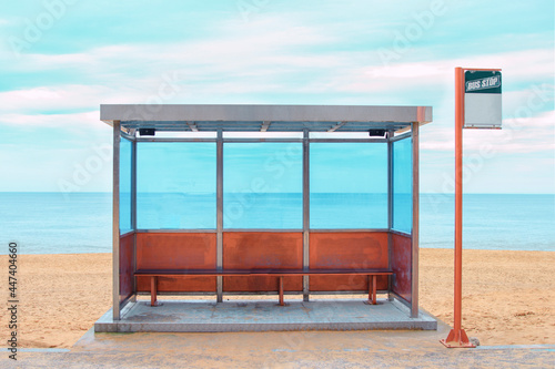 A bus stop is located in the background of the beach.