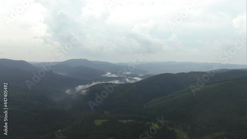 Rain Starting To Fall Over Lush Green Mountains In The Commune Of Izvoare In Romania On A Stormy Weather. aerial photo