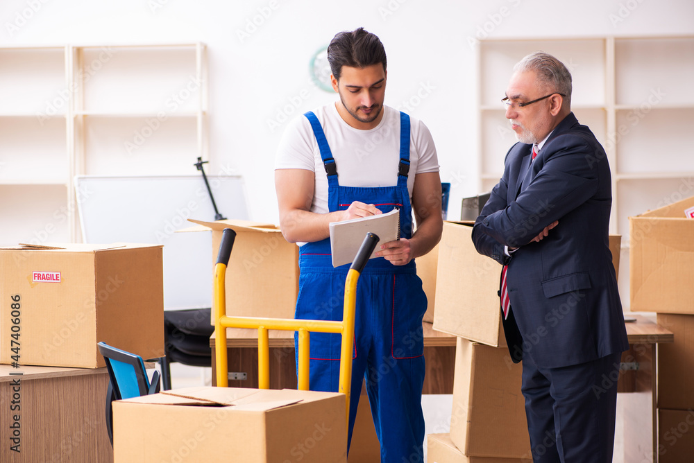 Old businessman and young contractor in relocation concept