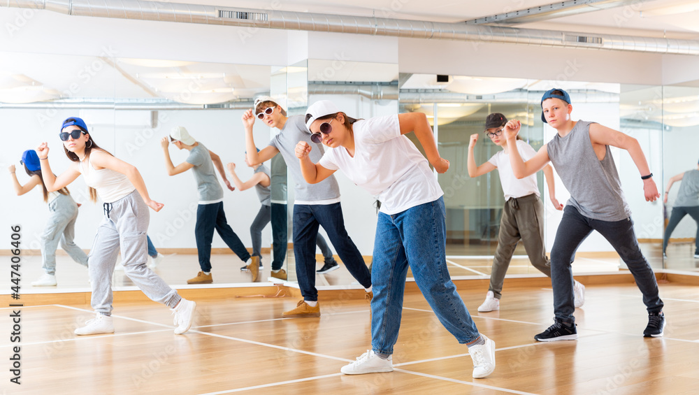 Fototapeta premium Happy girls and boy dancing hip hop in dancing class