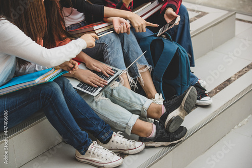 Slika na platnu Group of four young attractive asian girls college students studying together in university campus outdoor