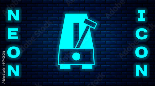 Glowing neon Classic Metronome with pendulum in motion icon isolated on brick wall background. Equipment of music and beat mechanism. Vector