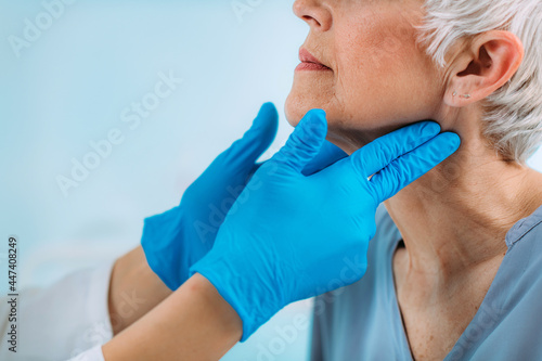 Thyroid Gland Control. Endocrinology Doctor Examining Senior Woman at Clinic.