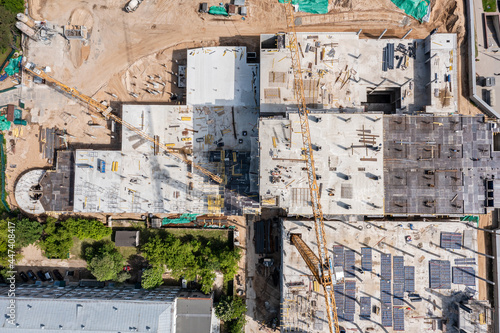 aerial top view of tower crane and building activity. construction site background. © Mr Twister