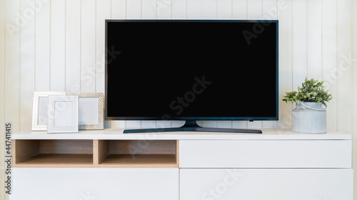 TV with Blank Screen Mock Up. Television on the cabinet in modern living room. © Kris Tan