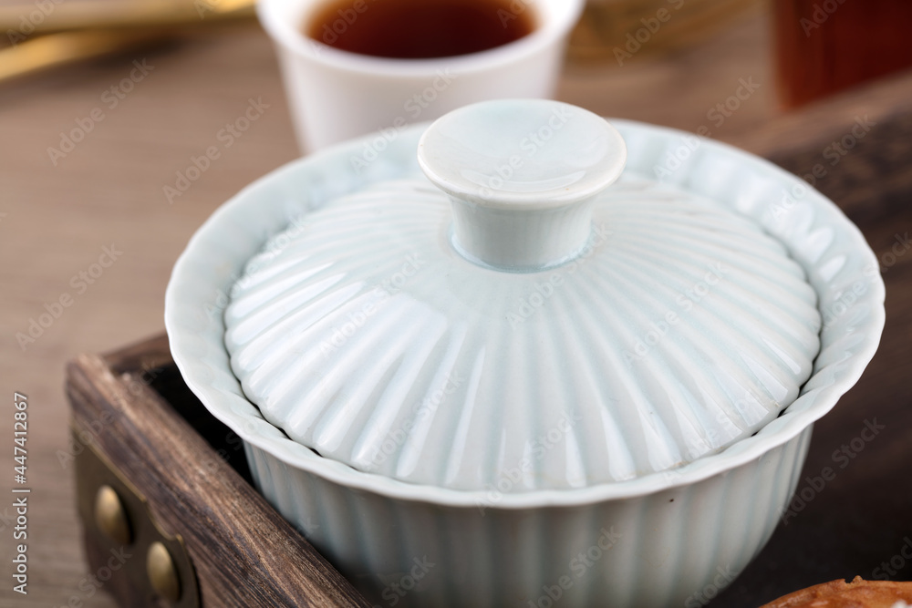 Gaiwan tea close-up in a wooden box plate Gaiwan tea close-up in a wooden box plate