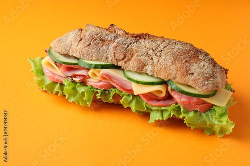 Sandwich of ciabatta bread on orange background