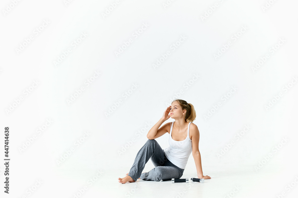 sportive woman sitting on the floor dumbbell in hands charging motivation energy exercise