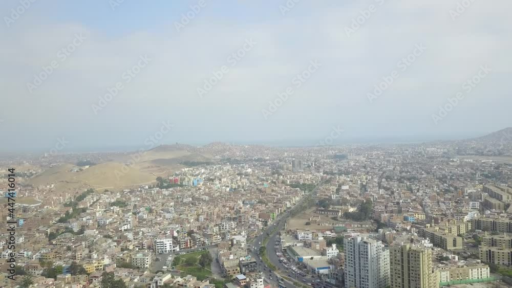 Aerial drone view of an urban environment with hills and the sea in mist in the background Aerial drone view of an urban environment with hills and the sea in mist in the background