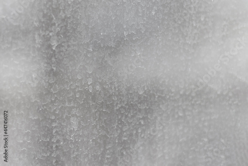 The surface of the dirty window glass, covered with dusty traces of raindrops. Blurred abstract texture.