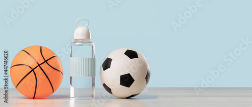 Football and basketball. Soccer ball with glass water bottle. Blue banner with copy space. School sports club education or classes. Gym