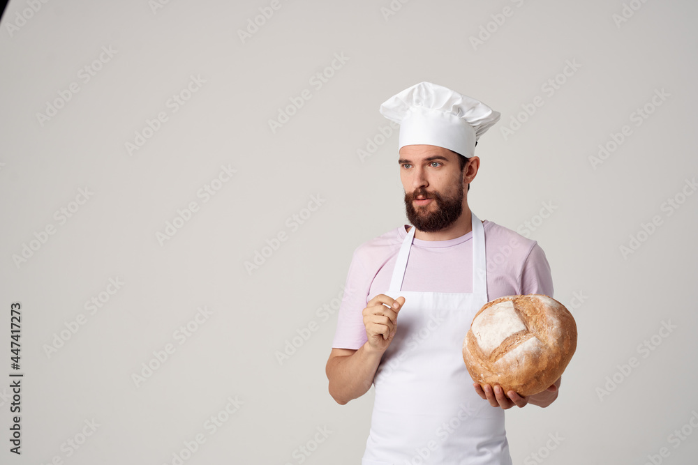 a man in a white apron with bread in his hands cooking cooking food a man in a white apron with bread in his hands cooking cooking food