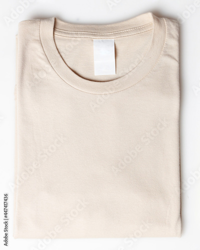 Cream color plain t-shirt mockup template. Plain t-shirt isolated on white background. Clothing for everyday. Perfect for your ad space. Space for your logo. Plain t-shirt for everyday wear.Focus blur