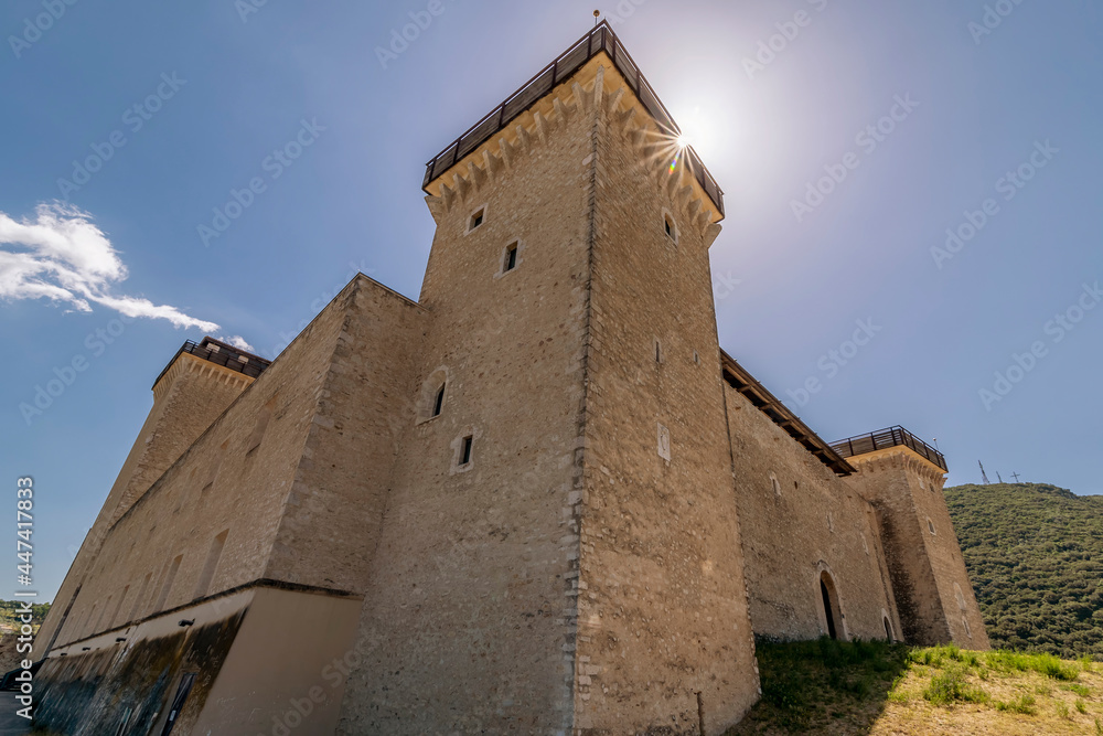 The sun filters over the top of the Rocca Albornoziana fortress in Spoleto, Italy