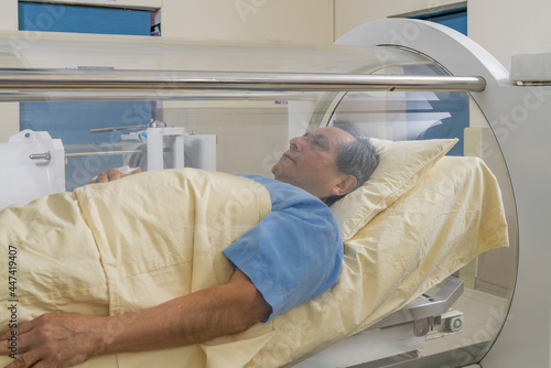 Man relaxed inside a machine for hyperbaric treatment