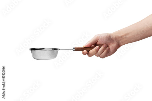 hand holding a flour sieve on a white background
