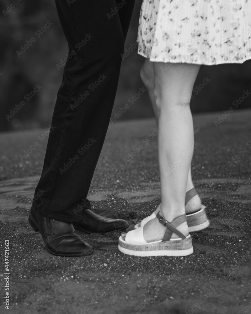 Legs of young hugging couple. Black and white