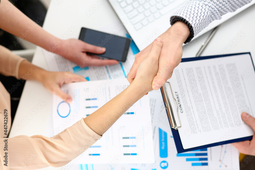Man in suit shake hand as hello in office closeup Man in suit shake hand as hello in office closeup
