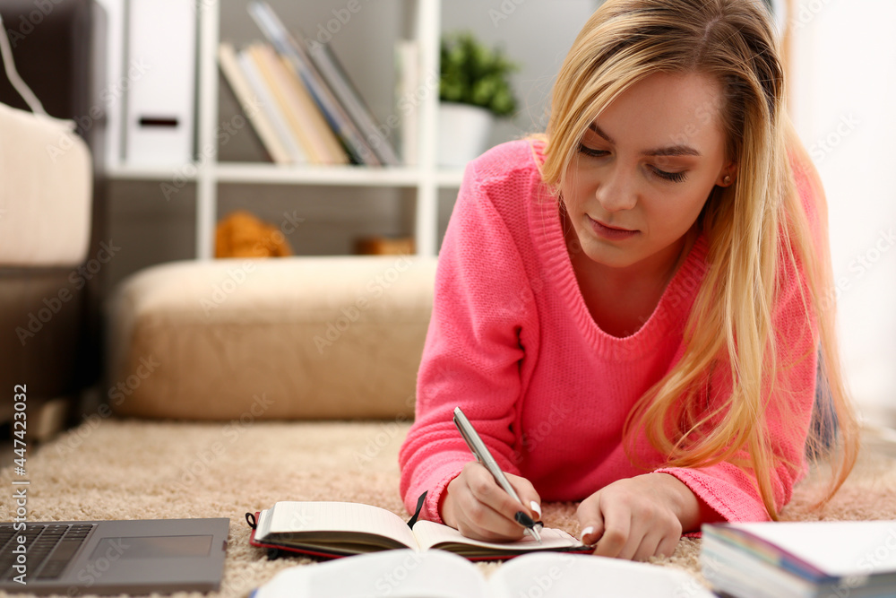 young beautiful blond woman lie on the floor read book young beautiful blond woman lie on the floor read book
