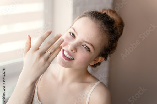 happy young woman showing wedding ring on her finger