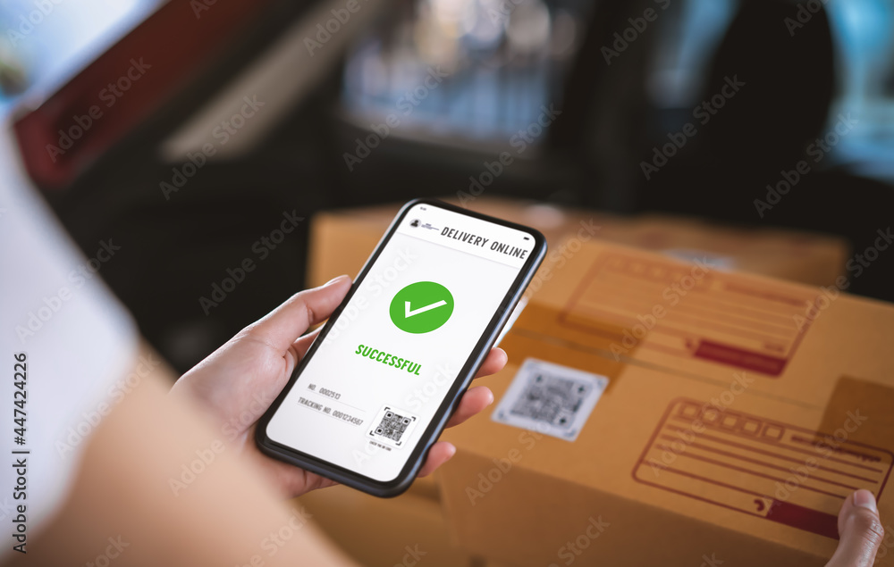 Startup small business, hand using smartphone with scan QR code on cardboard box delivery for products to send to customers. Startup small business, hand using smartphone with scan QR code on cardboard box delivery for products to send to customers.