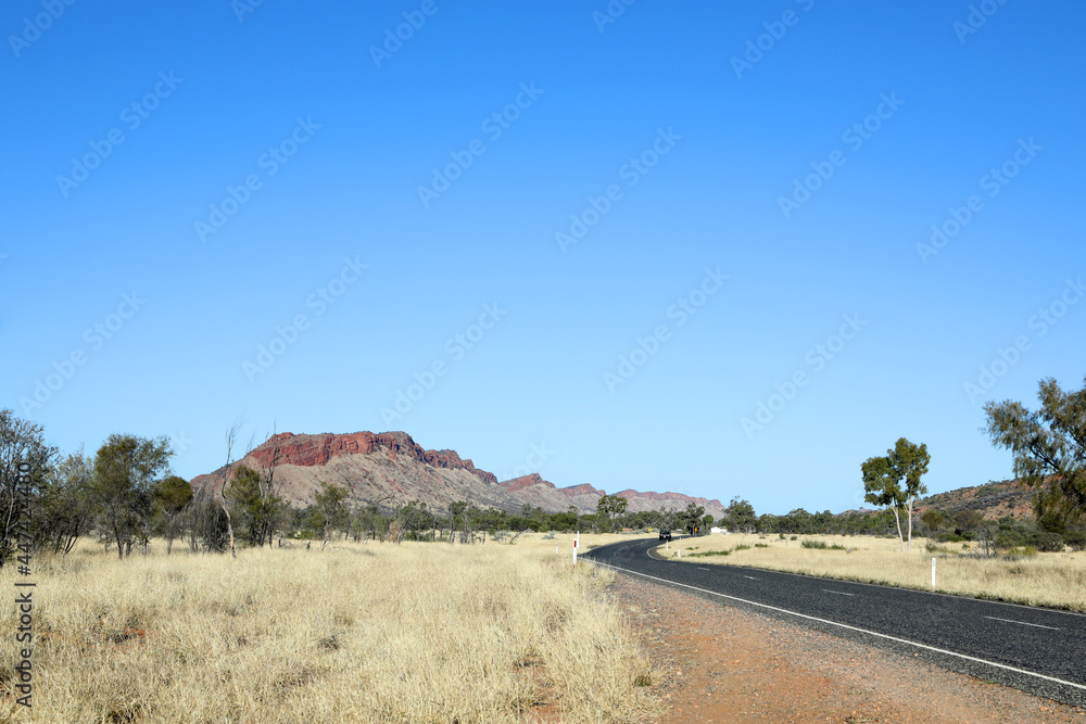 Fototapeta premium Detail image of Simpsons Gap in the MacDonnell Ranges near Alice Springs, Northern Territory, Australia featuring orange rock faces and beautiful ghost gum trees