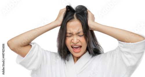 a woman wearing a towel holds her head and screams with a frustrated expression on a light gray background