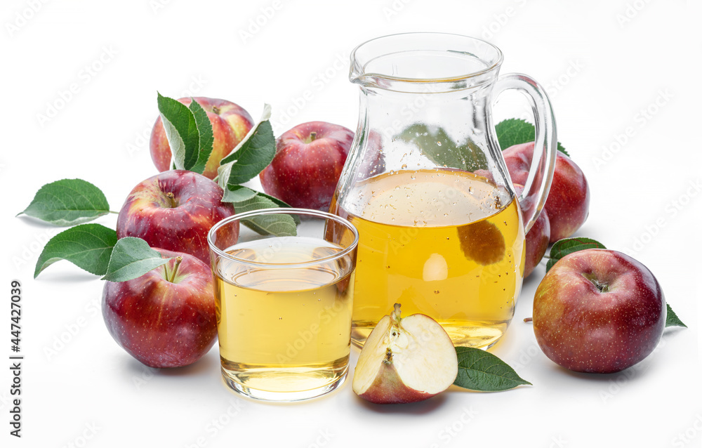 Glass and carafe of fresh apple juice and organic apples isolated on white background. Glass and carafe of fresh apple juice and organic apples isolated on white background.
