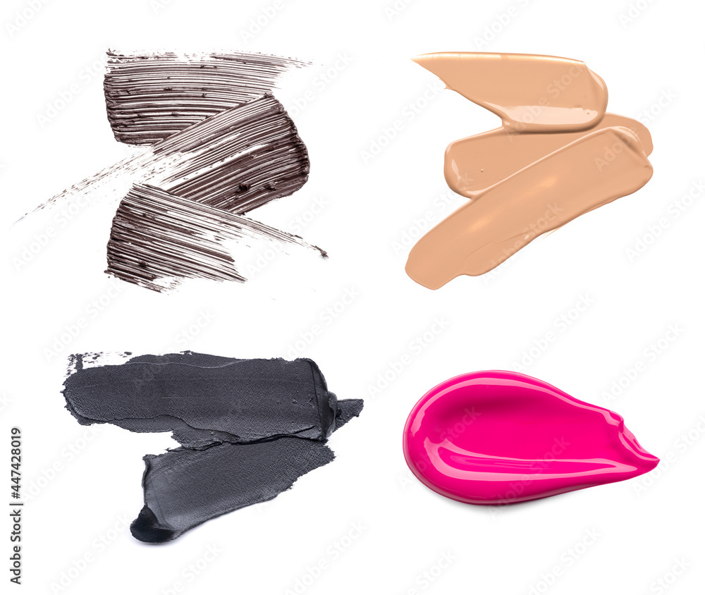 Set of cosmetic products. Smear of pink lipstick, brown smear of mascara and black eyeliner, foundation smears of makeup isolated on white background.