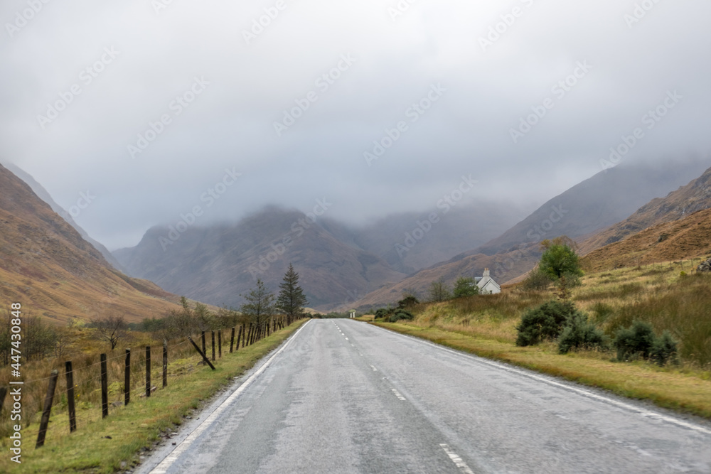 Road with Scenic Landscape View of Mountain, Forest in Scottish Highlands. Concept of Road trip, vacation.