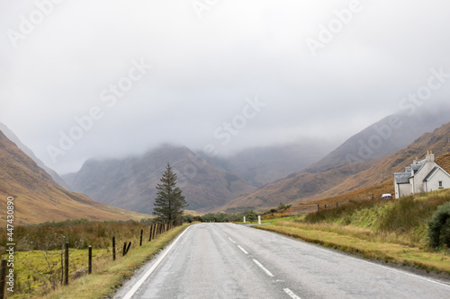 Road with Scenic Landscape View of Mountain  Forest in Scottish Highlands. Concept of Road trip  vacation.