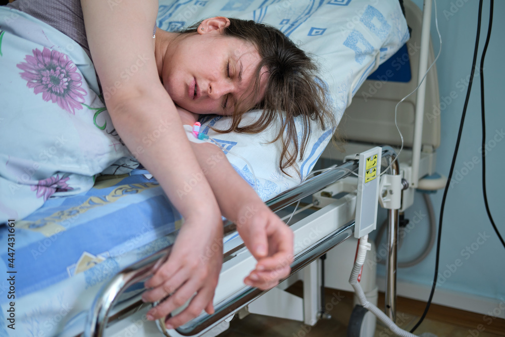 A pregnant woman gives birth in a hospital with a drip and a CTG machine A pregnant woman gives birth in a hospital with a drip and a CTG machine